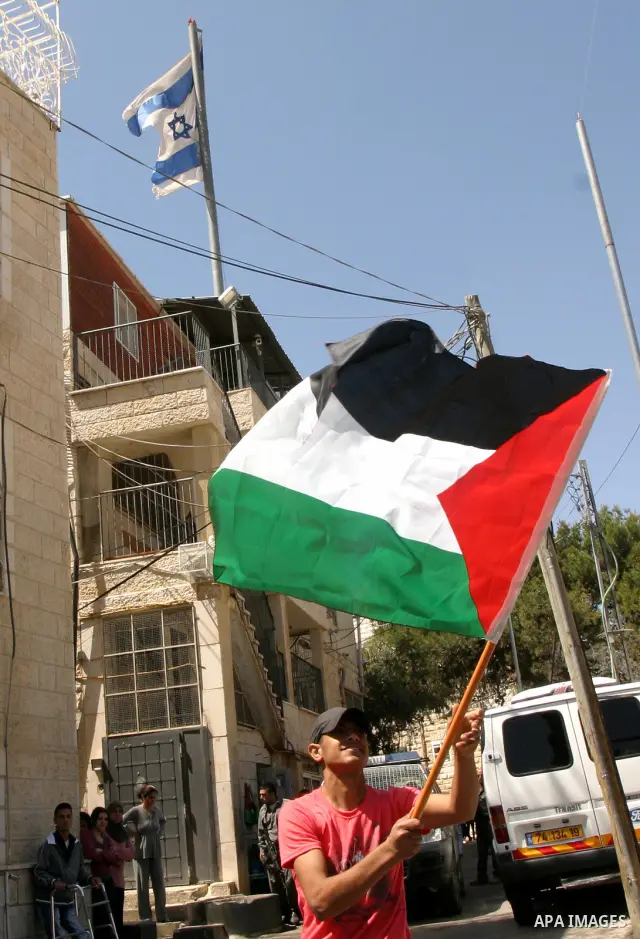 Palestinian demonstrate on the Mount of Olives, which overlooks the Dome of the Rock in the Al-Aqsa mosque compound, as they protest against the Jewish settlers who live in the Israeli annexed Arab East Jerusalem's a-Tur...