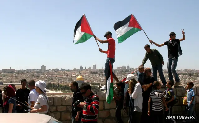 Palestinian demonstrate on the Mount of Olives, which overlooks the Dome of the Rock in the Al-Aqsa mosque compound, as they protest against the Jewish settlers who live in the Israeli annexed Arab East Jerusalem's a-Tur...
