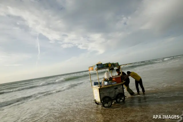 Palestinians enjoy at the beach in Gaza City, on April 20, 2012. Photo by Photo by Eyad Al Baba