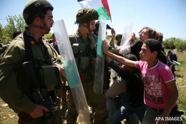 Israeli soldiers scuffle with Palestinian protesters during the weekly demonstration against settlement in the West Bank village Beit Ommar near Hebron.on April 21, 2012. Photo by Mamoun Wazwaz
