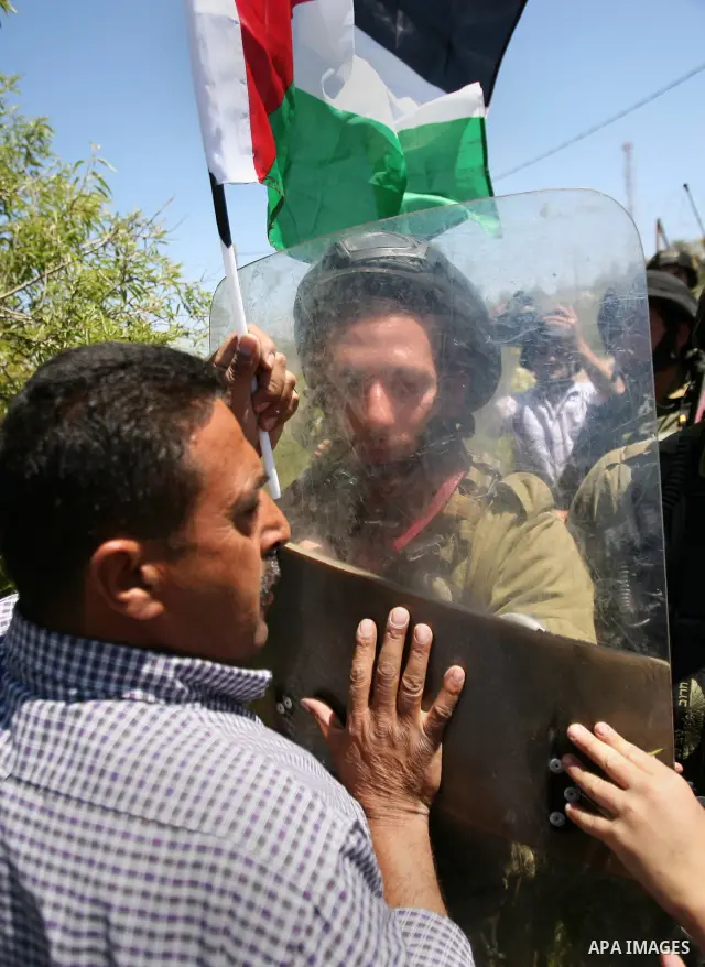 Israeli soldiers scuffle with Palestinian protesters during the weekly demonstration against settlement in the West Bank village Beit Ommar near Hebron.on April 21, 2012. Photo by Mamoun Wazwaz