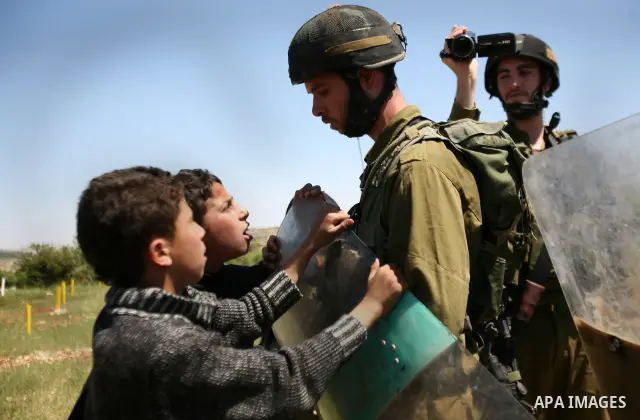 Israeli soldiers scuffle with Palestinian protesters during the weekly demonstration against settlement in the West Bank village Beit Ommar near Hebron.on April 21, 2012. Photo by Mamoun Wazwaz
