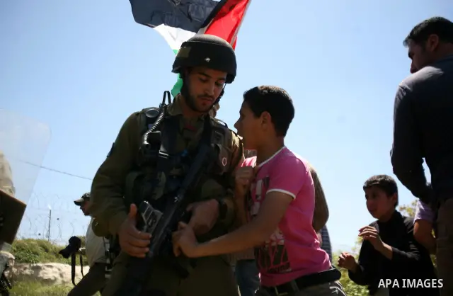 Israeli soldiers scuffle with Palestinian protesters during the weekly demonstration against settlement in the West Bank village Beit Ommar near Hebron.on April 21, 2012. Photo by Mamoun Wazwaz