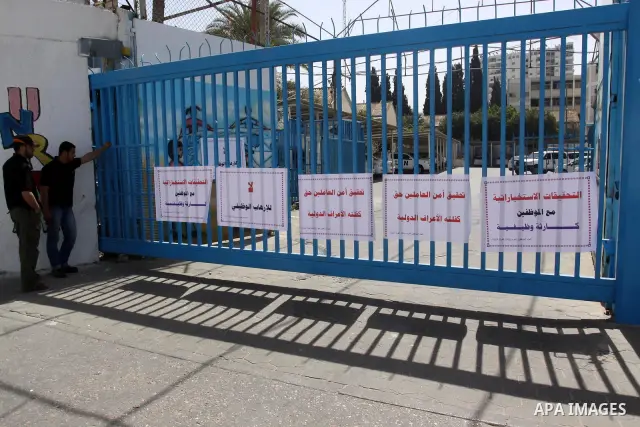 Palestinians participate during a protest in front of the UNRWA office against the mechanism Intelligence investigation that uses to their staff in Gaza City, on April 22, 2012. Photo by Mohammed Asad