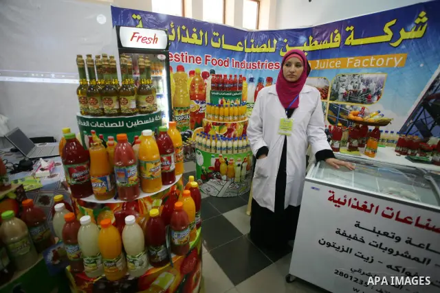 Palestinians participate in the opening of an exhibition of national products at the Islamic University in Gaza city on April 22, 2012. Photo by Naaman Omar