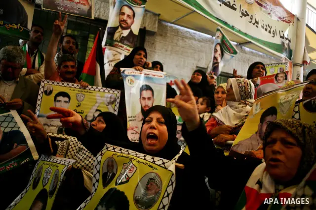Palestinian women shout slogans during a demonstration for the release of Palestinian prisoners held in Israeli jails outside the Red Cross offices in Gaza City on April 23, 2012. At least 1,350 Palestinian prisoners bei...