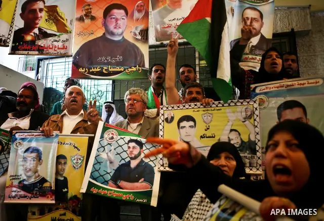 Palestinian women shout slogans during a demonstration for the release of Palestinian prisoners held in Israeli jails outside the Red Cross offices in Gaza City on April 23, 2012. At least 1,350 Palestinian prisoners bei...