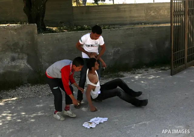 Palestinians carry a wounded demonstrator injured during clashes near their school at Oref Village near the West Bank City of Nablus on 23 April 2012 .Israeli settlers from Jewish settlement of Yetshar attacked the schoo...