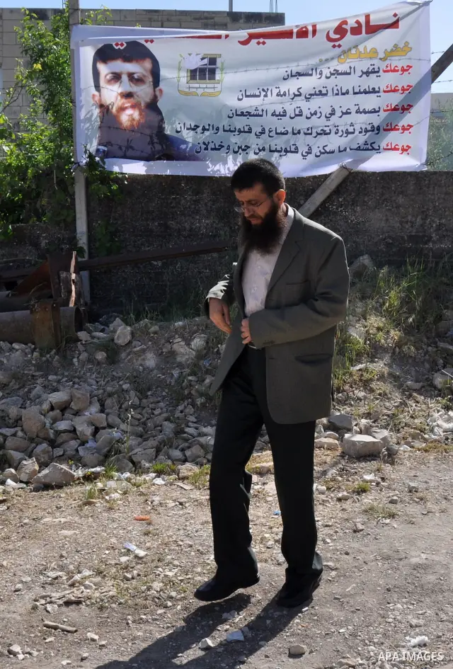 Former Palestinian hunger strike prisoner Khader Adnan, a senior member of Islamic Jihad who was jailed in Israel, walks in front of his house in the village of Arraba near the northern city of Jenin, in the Israeli occu...