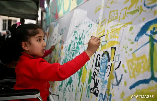 Palestinian disabled children draw and paint pictures at a charity association during a celebration in Gaza city on April 23,2012. Photo by Ali Jadallah