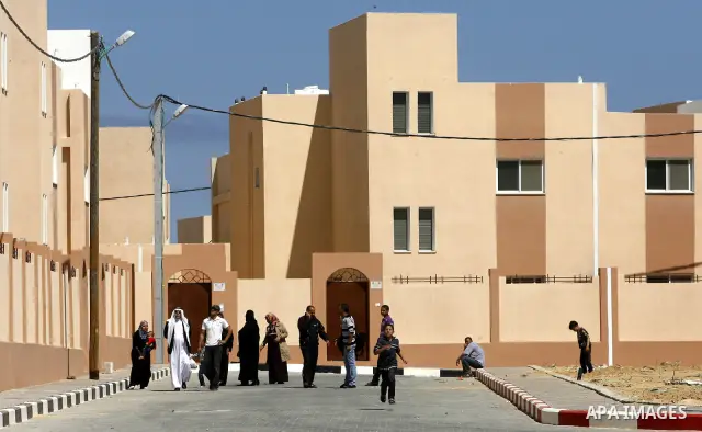 Palestinians take part a ceremony distributing new homes in Khan Younis in the southern Gaza Strip April 24, 2012. Palestinians, whose houses were destroyed during Israeli military operations in 2004 and 2005, received a...
