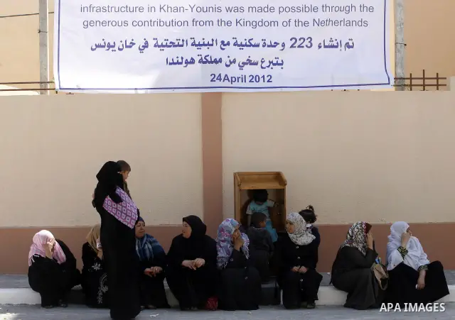Palestinians take part a ceremony distributing new homes in Khan Younis in the southern Gaza Strip April 24, 2012. Palestinians, whose houses were destroyed during Israeli military operations in 2004 and 2005, received a...
