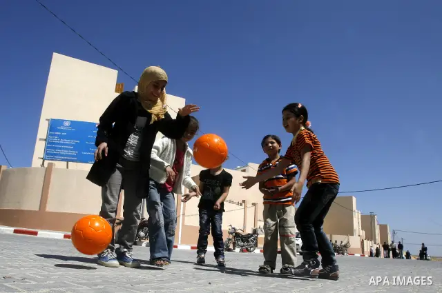 Palestinians Children play during a ceremony distributing new homes in Khan Younis in the southern Gaza Strip April 24, 2012. Palestinians, whose houses were destroyed during Israeli military operations in 2004 and 2005,...