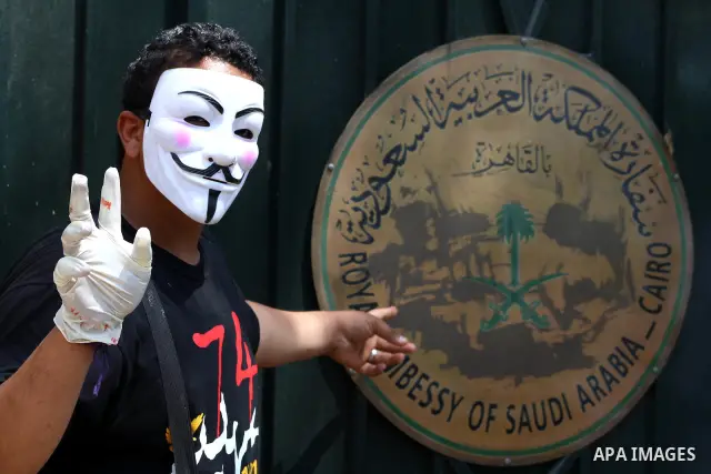 An Egyptian protester wears a mask during a demonstration in front of Saudi Arabian embassy in Cairo on April 24, 2012 calling for the release of the Egyptians who have been detained in the kingdom, including Ahmed al-Gi...