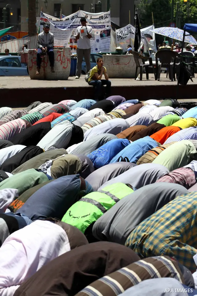 Egyptian demonstrators attend pray during a protest at Tahrir Square in Cairo, Egypt on April 25, 2012. Several thousand Egyptians are protesting against the country's military rulers. Photo by Ashraf Amra