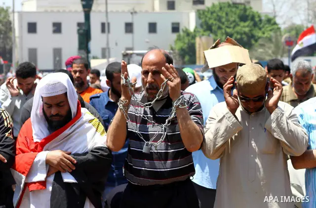Egyptian demonstrators attend pray during a protest at Tahrir Square in Cairo, Egypt on April 25, 2012. Several thousand Egyptians are protesting against the country's military rulers. Photo by Ashraf Amra