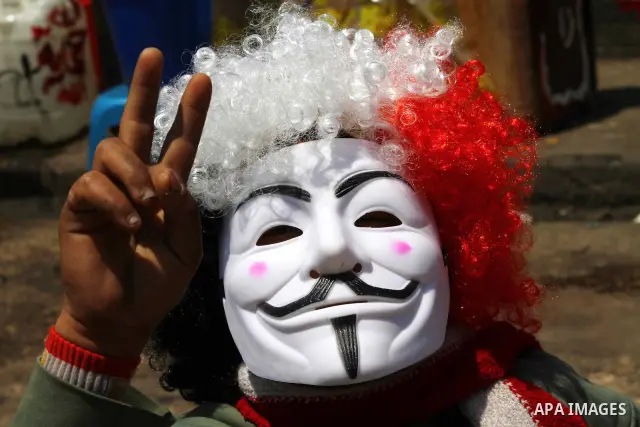 Egyptian masked man chants slogans during a protest at Tahrir Square in Cairo, Egypt on April 25, 2012. Several thousand Egyptians are protesting against the country's military rulers. Photo by Ashraf Amra