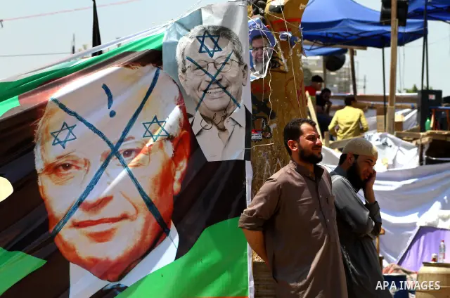 Egyptian demonstrators holding up portraits during a protest at Tahrir Square in Cairo, Egypt on April 25, 2012. Several thousand Egyptians are protesting against the country's military rulers. Photo by Ashraf Amra