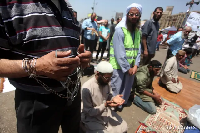 Egyptian demonstrators attend pray during a protest at Tahrir Square in Cairo, Egypt on April 25, 2012. Several thousand Egyptians are protesting against the country's military rulers. Photo by Ashraf Amra