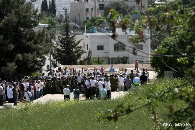 Israeli settler stands during pray in front of a Jewish cemetery near the settlement of Tel Rumeida, in the West Bank City of Hebron, on April 25, 2012. Photo by Mamoun Wazwaz