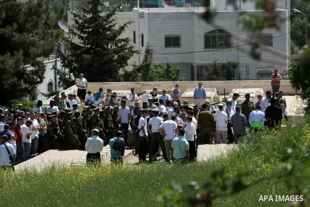 Israeli settler stands during pray in front of a Jewish cemetery near the settlement of Tel Rumeida, in the West Bank City of Hebron, on April 25, 2012. Photo by Mamoun Wazwaz
