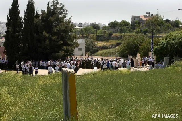 Israeli settler stands during pray in front of a Jewish cemetery near the settlement of Tel Rumeida, in the West Bank City of Hebron, on April 25, 2012. Photo by Mamoun Wazwaz