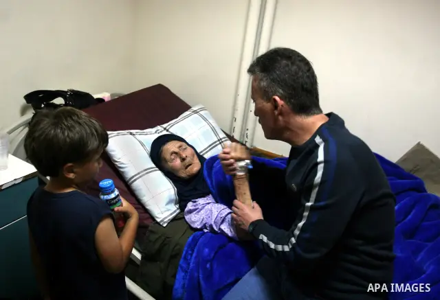 Palestinian activist Bassem Tamimi with his mother in a hospital in Ramallah on April 25, 2012, after a military court released him on bail on April 24, ahead of the verdict in his trial on charges of organising popular...