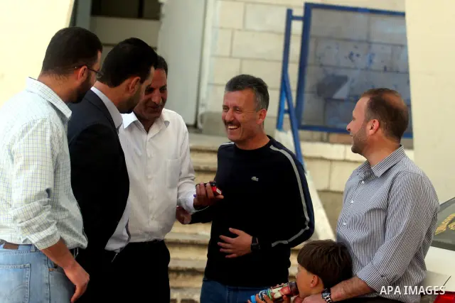 Palestinian activist Bassem Tamimi with his relatives at a hospital in Ramallah on April 25, 2012, after a military court released him on bail on April 24, ahead of the verdict in his trial on charges of organising popul...