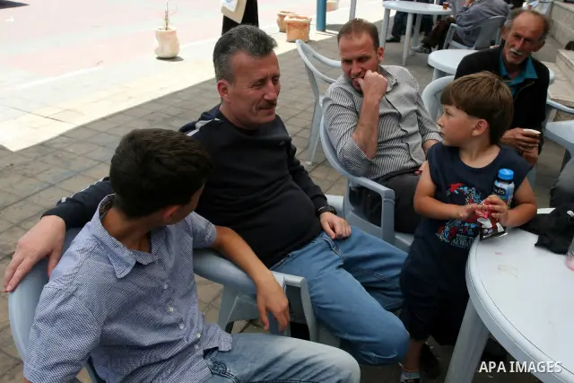 Palestinian activist Bassem Tamimi with his relatives at a hospital in Ramallah on April 25, 2012, after a military court released him on bail on April 24, ahead of the verdict in his trial on charges of organising popul...