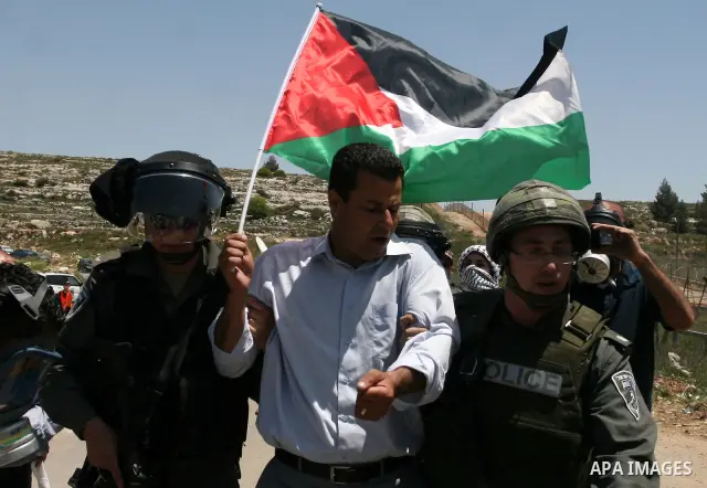 Israeli police detain a Palestinian during a rally calling for the release of Palestinian prisoners jailed in Israel, near the West Bank city of Ramallah, Thursday, April 26, 2012. Photo by Issam Rimawi