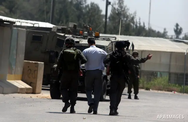 Israeli police detain a Palestinian during a rally calling for the release of Palestinian prisoners jailed in Israel, near the West Bank city of Ramallah, Thursday, April 26, 2012. Photo by Issam Rimawi