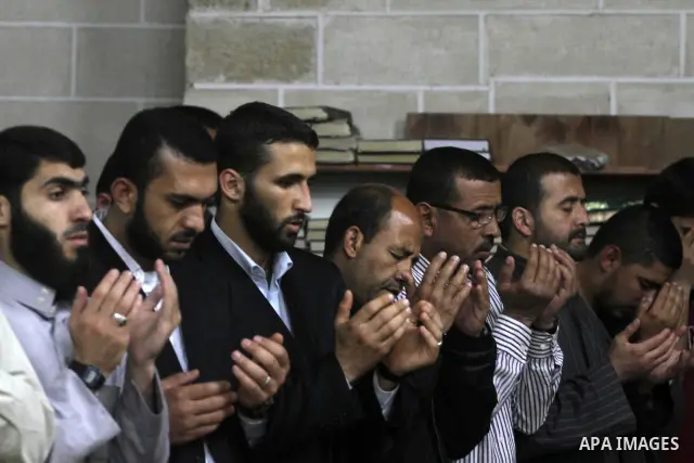 Palestinian Prime Minister in Gaza Ismail Hania (not seen), attend by Legislative Council members, Ministers and Clerics in Gaza, during a prayer for the prisoners in Israeli jails. in Gaza city on April 26, 2012.. Photo...