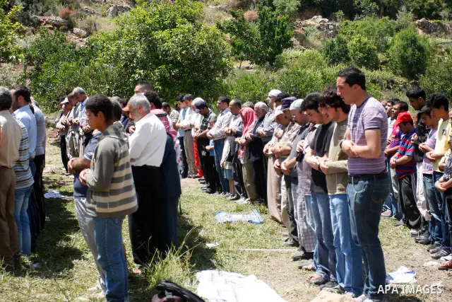 Palestinians pray during a protest against land confiscation by nearby Jewish settlements, Wadi Qana, in the West Bank village Deir Istia , Friday, April 27, 2012 . Photo by Wagdi Eshtayah
