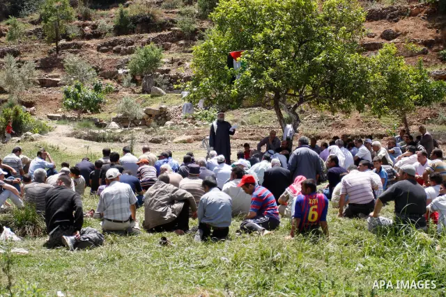 Palestinians pray during a protest against land confiscation by nearby Jewish settlements, Wadi Qana, in the West Bank village Deir Istia , Friday, April 27, 2012 . Photo by Wagdi Eshtayah