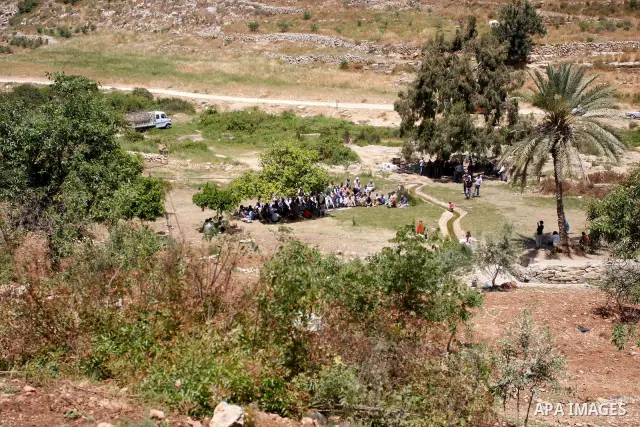 Palestinians pray during a protest against land confiscation by nearby Jewish settlements, Wadi Qana, in the West Bank village Deir Istia , Friday, April 27, 2012 . Photo by Wagdi Eshtayah