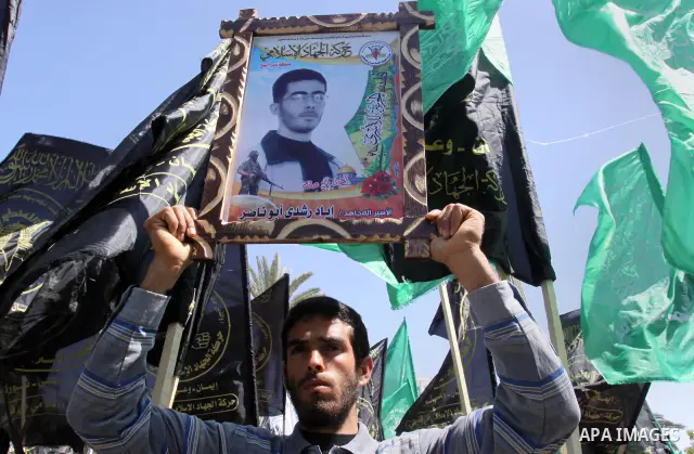Palestinian protesters hold up banners and portraits during a protest to call for the release of Palestinian prisoners held in Israeli jails in Gaza City on April 27, 2012. Some 1,600 Palestinian prisoners held in Israel...