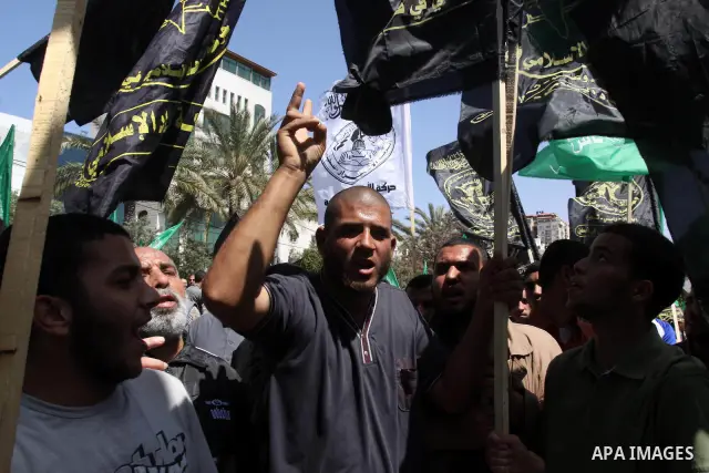Palestinian protesters hold up banners and portraits during a protest to call for the release of Palestinian prisoners held in Israeli jails in Gaza City on April 27, 2012. Some 1,600 Palestinian prisoners held in Israel...