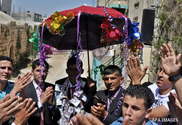 Relatives Palestinian groom Abbas Thawabteh, dancing during heritage wedding in the village of Azmut eastern city of Nablus in the West Bank,on 27 April 2012. Photo by Nedal Shtieh. Photo by Nedal Shtieh
