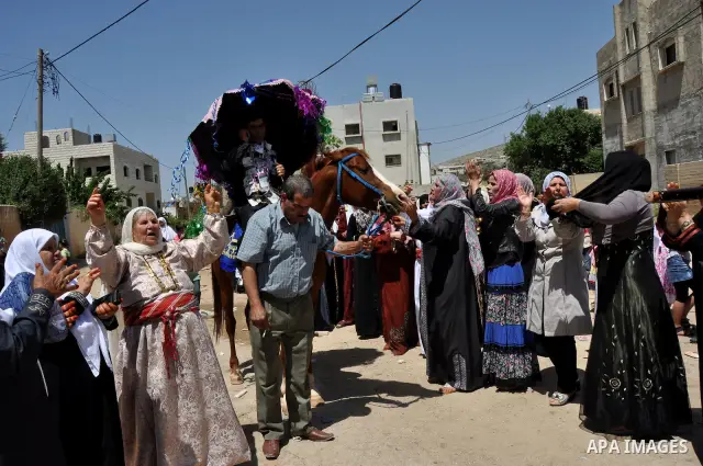 Relatives Palestinian groom Abbas Thawabteh, dancing during heritage wedding in the village of Azmut eastern city of Nablus in the West Bank,on 27 April 2012. Photo by Nedal Shtieh. Photo by Nedal Shtieh