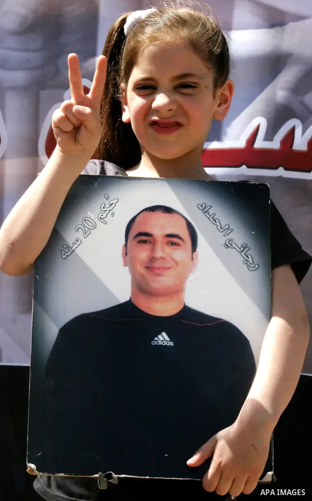 Palestinians hold portraits of relatives jailed in Israeli prisons as they protest to demand for their release, in the Al Aqsa Mosque compound in Jerusalem's Old City, on April 27, 2012. After decades of shying away from...
