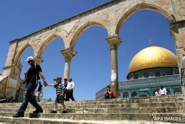 A Palestinian family walks past the Dome of the Rock Mosque in the Al Aqsa Mosque compound in Jerusalem's Old City, on April 27, 2012. After decades of shying away from an ancient pilgrimage route, Muslims are visiting J...