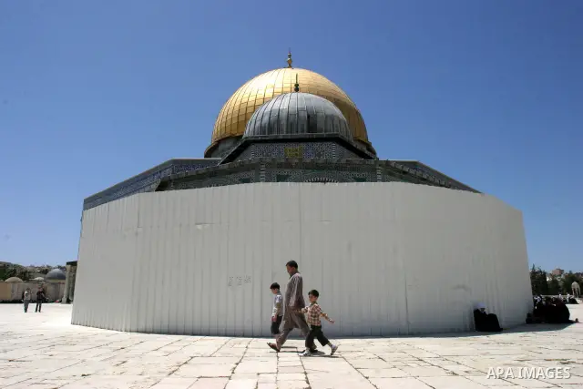 A Palestinian family walks past the Dome of the Rock Mosque in the Al Aqsa Mosque compound in Jerusalem's Old City, on April 27, 2012. After decades of shying away from an ancient pilgrimage route, Muslims are visiting J...
