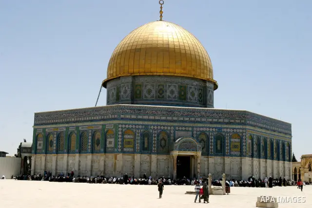 A Palestinian family walks past the Dome of the Rock Mosque in the Al Aqsa Mosque compound in Jerusalem's Old City, on April 27, 2012. After decades of shying away from an ancient pilgrimage route, Muslims are visiting J...
