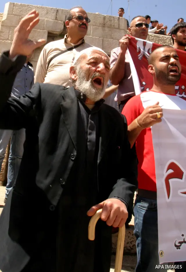 Palestinians hold portraits of relatives jailed in Israeli prisons as they protest to demand for their release, in the Al Aqsa Mosque compound in Jerusalem's Old City, on April 27, 2012. After decades of shying away from...