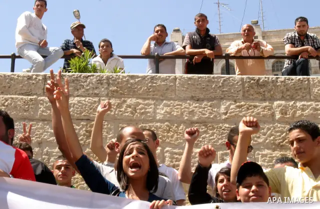 Palestinians hold portraits of relatives jailed in Israeli prisons as they protest to demand for their release, in the Al Aqsa Mosque compound in Jerusalem's Old City, on April 27, 2012. After decades of shying away from...