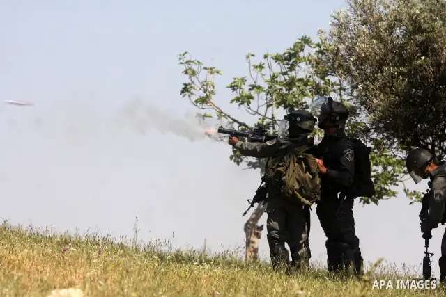 Israeli forces, firing tear gas during a weekly demonstration for Palestinians demonstrators against the expansion of the nearby Jewish settlement of Halamish in the West Bank village of Nabi Saleh near Ramallah, Friday,...