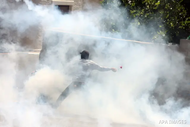 Palestinian youths and Israeli troops clash during a weekly demonstration against the expansion of the nearby Jewish settlement of Halamish in the West Bank village of Nabi Saleh near Ramallah, Friday, April 27, 2012. Ph...