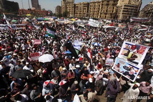 People attend Friday prayers in Tahrir Square in Cairo April 27, 2012. Tens of thousands of Egyptians demanded on Friday that their military rulers stick to a pledge to hand over power by mid-year after a row over who ca...