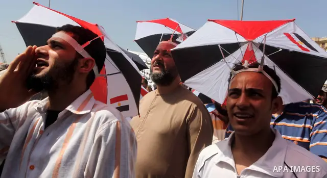 People attend Friday prayers in Tahrir Square in Cairo April 27, 2012. Tens of thousands of Egyptians demanded on Friday that their military rulers stick to a pledge to hand over power by mid-year after a row over who ca...