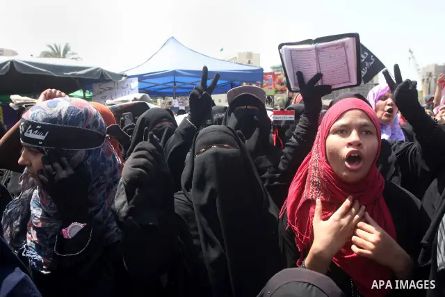 People attend Friday prayers in Tahrir Square in Cairo April 27, 2012. Tens of thousands of Egyptians demanded on Friday that their military rulers stick to a pledge to hand over power by mid-year after a row over who ca...